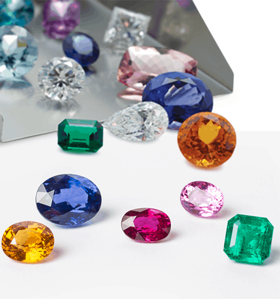 Number of coloured gemstones lying on the surface used on the certified course advanced gemstone charter offered by SGL labs.