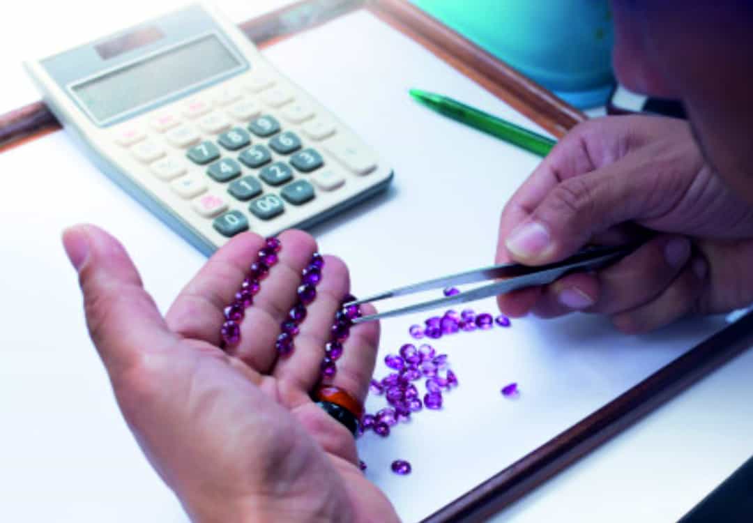 Gemstones being graded by a gemologist at SGL Labs.